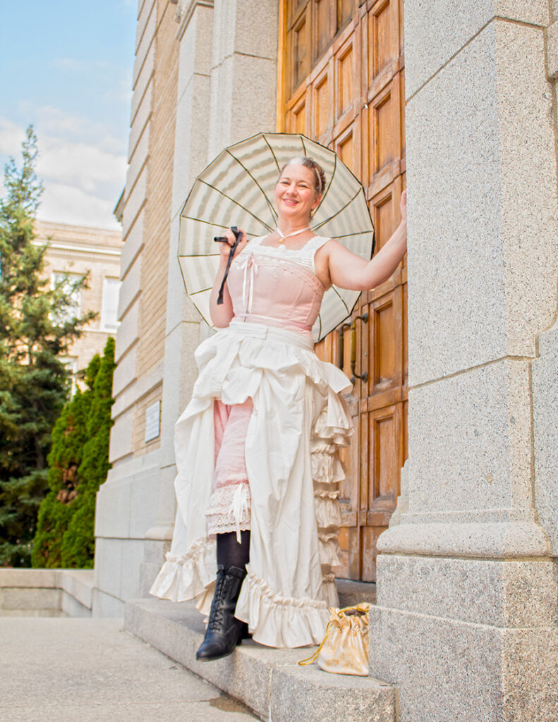 Monique Bouchard as Madame History stands in the doorway of the Bangor Public Library